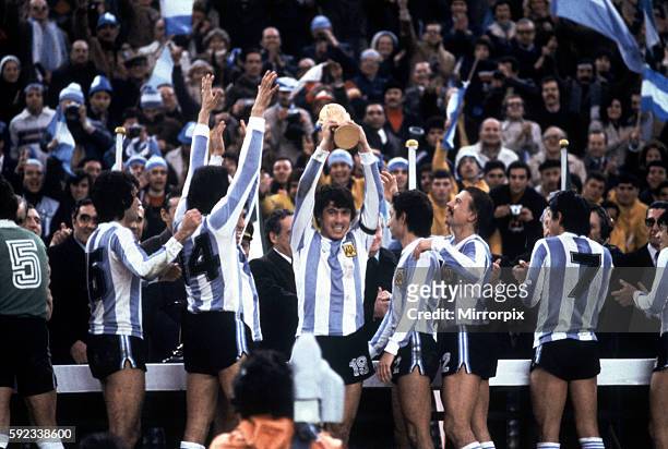 Argentina won 3-1 aet, Mario Kempes scoring twice. Pictured: Argentina with the trophy. Daniel Passarella Captain lifts the trophy, also pictured,...