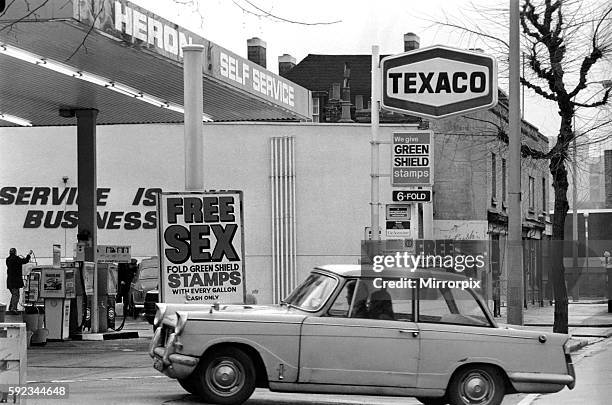 In a bid to get business in the Easter Petrol War. A Bermondsey Petrol Station sign says 'Free Sex' but it should read "free six-fold green shield...