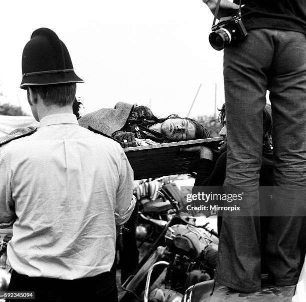 Scene at POP Festival, Weeley, Essex, following a battle between security men and Hells Angels, a young Hells Angel leaves the 'battlefield' on a...