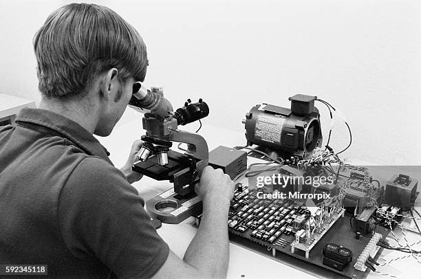 Technician examines board of micro chips.