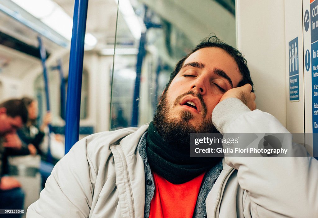 Man sleeping on the subway