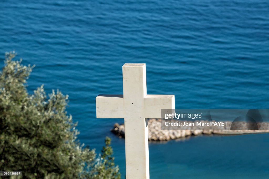 White cross in cemetery above the sea