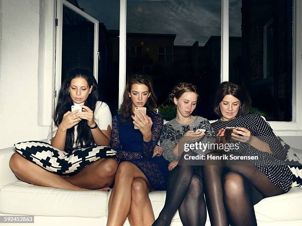 group of young people having a party - group on couch stock-fotos und bilder