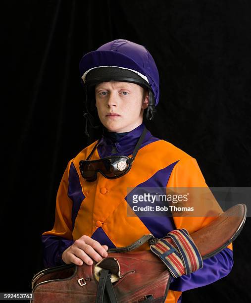 jockey with saddle and helmet - racing silks fotografías e imágenes de stock