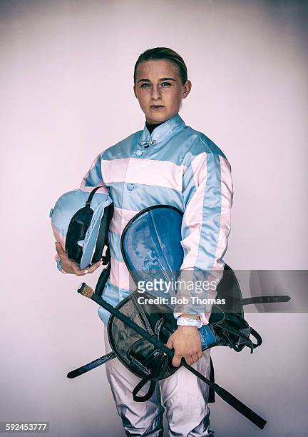 female jockey with saddle and helmet - jockey stock-fotos und bilder