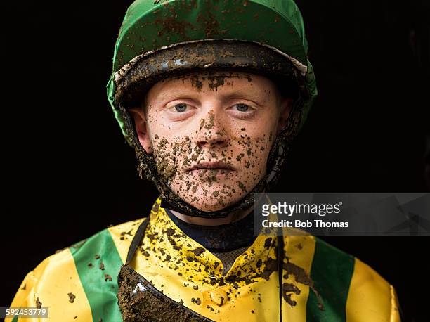 jockey with mud splattered face - jockey stock-fotos und bilder