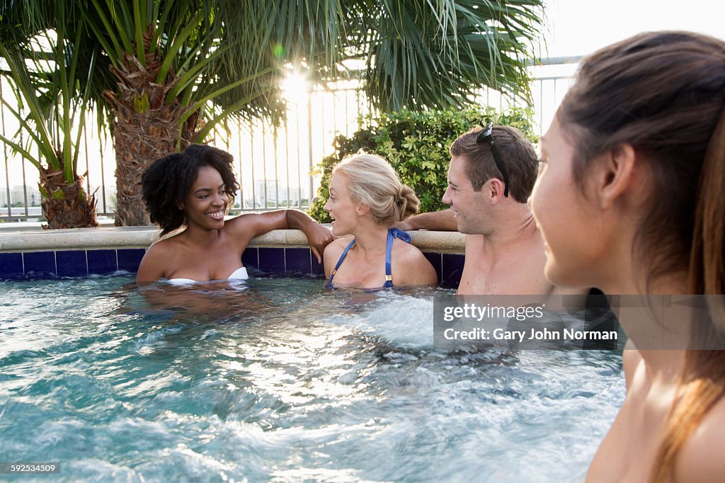 Group of  friends chatting in outdoor spa
