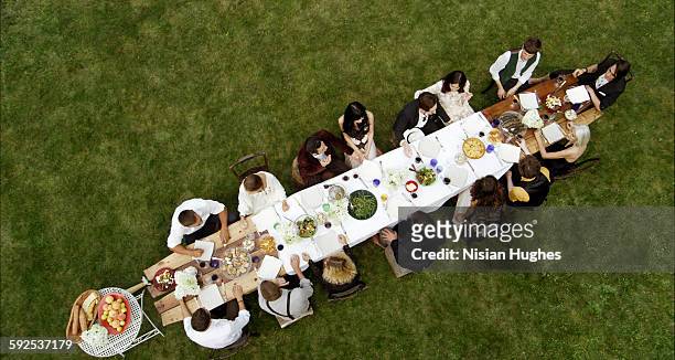 shot above looking down friends at outdoor dinner - dining table stock pictures, royalty-free photos & images