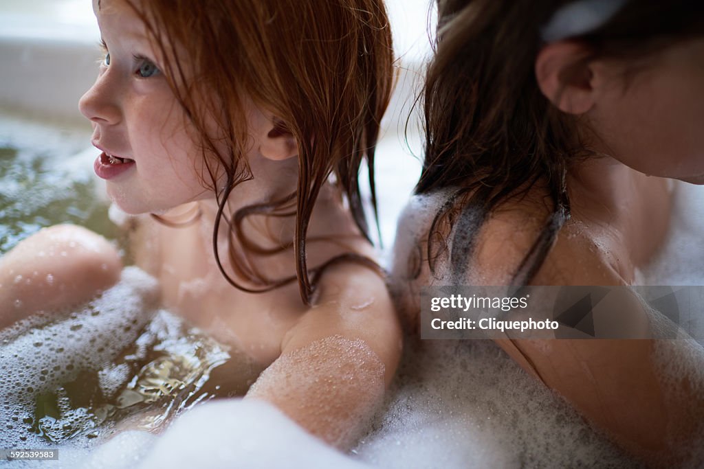Sisters in bubble bath