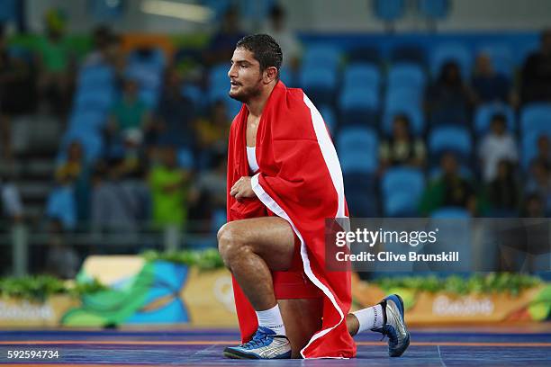 Taha Akgul of Turkey celebrates victory against Komeil Nemat Ghasemi of the Islamic Republic of Iran in the Men's Freestyle 125kg Gold Medal bout on...