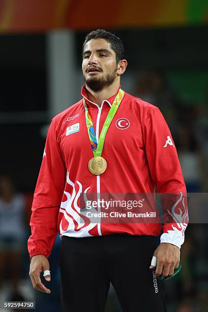 Gold medalist Taha Akgul of Turkey poses on the podium during the medal ceremony for the Men's Freestyle 125kg Wrestling on Day 15 of the Rio 2016...