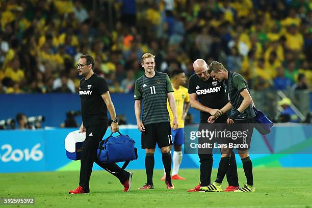 Lars Bender of Germany is injured during the Men's Football Final between Brazil and Germany at the Maracana Stadium on Day 15 of the Rio 2016...