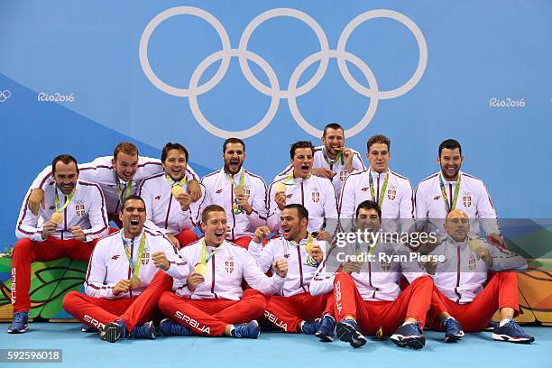 Gold medalists Team Serbia celebrate on the podium during the medal ceremony for the Men's Water Polo Gold Medal match between Croatia and Serbia on...