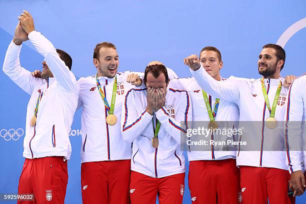 Gold medalists Team Serbia celebrate on the podium during the medal ceremony for the Men's Water Polo Gold Medal match between Croatia and Serbia on...
