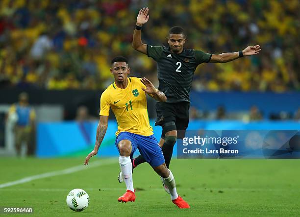 Gabriel Jesus of Brazil and Jeremy Toljan of Germany during the Men's Football Final between Brazil and Germany at the Maracana Stadium on Day 15 of...