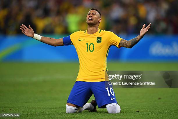 Neymar of Brazil celebrates scoring the winning penalty in the penalty shoot out during the Men's Football Final between Brazil and Germany at the...