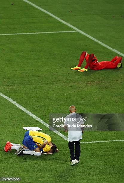 Neymar of Brazil celebrates scoring the winning penalty in the penalty shoot out as German keeper Timo Horn of Germany lays despondent during the...