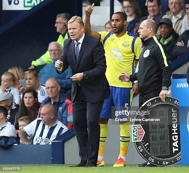 Everton manager Ronald Koeman with substitute Ashley Williams as 4th Official Scott Duncan uses the Tag Heuer Board during the Premier League match...