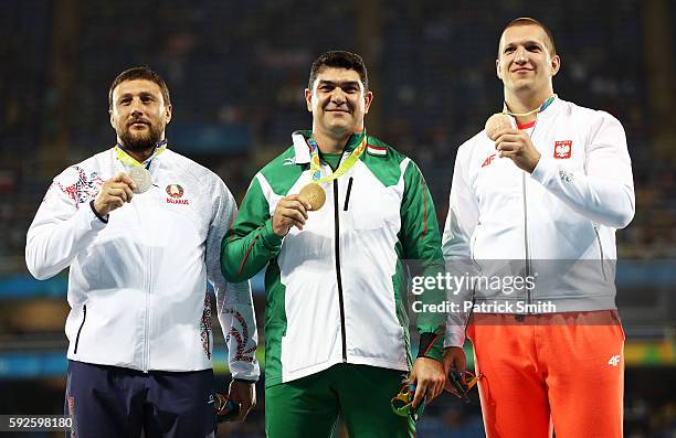 Silver medalist Ivan Tsikhan of Belarus, gold medalist Dilshod Nazarov of Tajikistan and bronze medalist Wojciech Nowick of Poland stand on the...