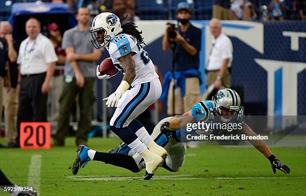 Dexter McCluster of the Tennessee Titans maneuvers past Colin Jones of the Carolina Panthers during the first half at Nissan Stadium on August 20,...