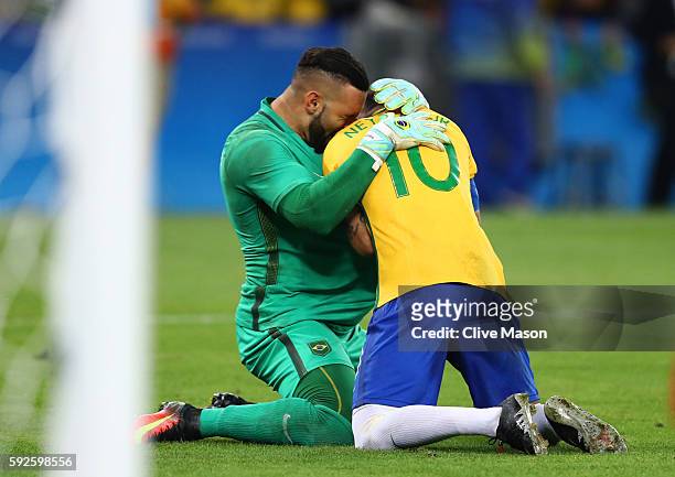 Neymar of Brazil celebrates with goalkeeper Weverton after scoring the winning penalty in the penalty shoot out during the Men's Football Final...