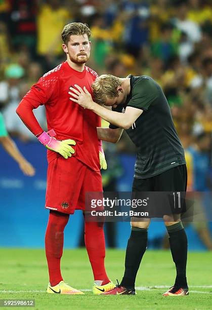 Timo Horn of Germany and team mate Julian Brandt of Germany react after losing in the penalty shoot out during the Men's Football Final between...