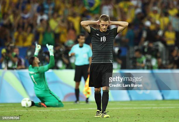 Weverton the Brazil goalkeeper saves the penalty taken by Nils Petersen of Germany during the penalty shoot out in the Men's Football Final between...