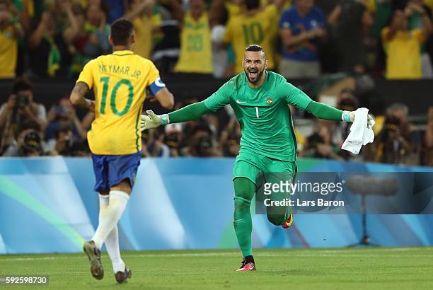 Neymar of Brazil celebrates with goalkeeper Weverton after scoring the winning penalty in the penalty shoot out during the Men's Football Final...