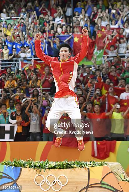 Chinese badminton player Chen Long jumps onto the podium during the medal ceremony after winning the men's singles gold at the Rio Olympics on Aug....