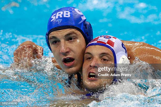 Luka Loncar of Croatia and Nikola Jaksic of Serbia compete for the ball during the Men's Water Polo Gold Medal match between Croatia and Serbia on...