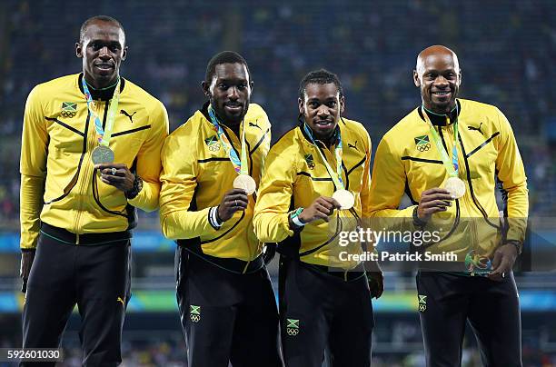 Gold medalists Asafa Powell, Yohan Blake, Nickel Ashmeade and Usain Bolt of Jamaica stand on the podium during the medal ceremony for the Men's 4 x...