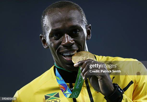 Gold medalist Usain Bolt of Jamaica stands on the podium during the medal ceremony for the Men's 4 x 100 meter Relay on Day 15 of the Rio 2016...