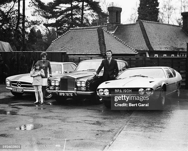 Portrait of millionaire song writer Les Reed and his three luxury cars, including his new Lamborghini, with his wife and daughter Donna, who is...