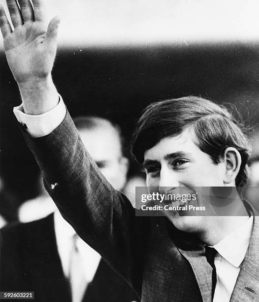 Prince Charles waving to onlookers as he arrives on a Royal Tour of Australia, where he will attend the funeral of President Holt, who recently...