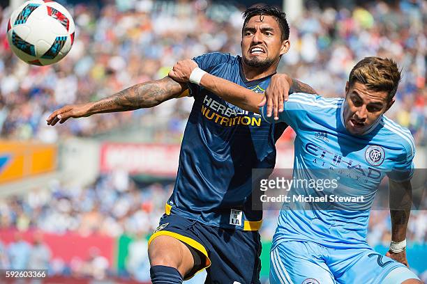 Defenders Ronald Matarrita of New York City FC and A. J. DeLaGarza of Los Angeles Galaxy vie for the ball during the match at Yankee Stadium on...