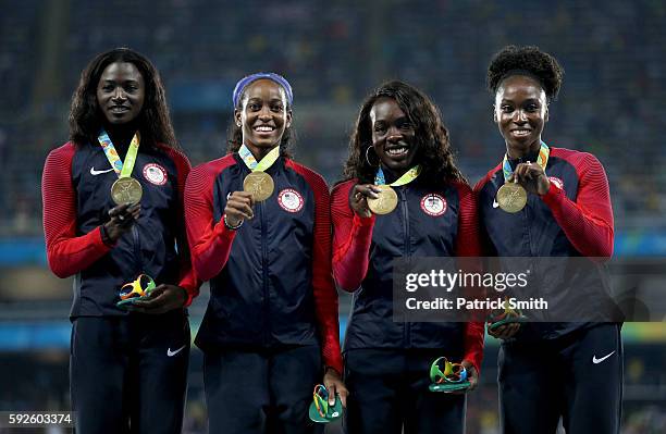 Gold medalists Tori Bowie, English Gardner, Morolake Akinosun, and Tianna Bartoletta of the United States stand on the podium during the medal...