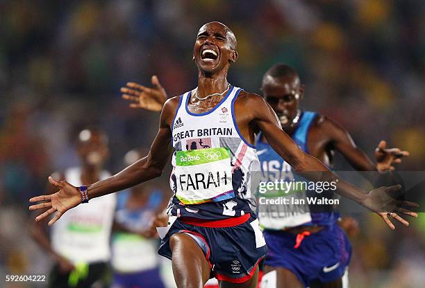 Mohamed Farah of Great Britain reacts after winning gold in front of Paul Kipkemoi Chelimo of the United States in the Men's 5000 meter on Day 15 of...