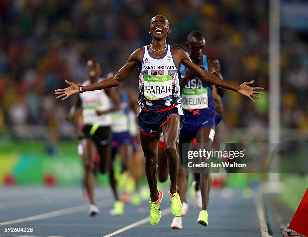 Mohamed Farah of Great Britain reacts after winning gold in front of Paul Kipkemoi Chelimo of the United States in the Men's 5000 meter on Day 15 of...