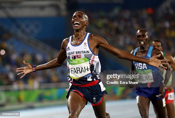 Mohamed Farah of Great Britain reacts after winning gold in front of Paul Kipkemoi Chelimo of the United States in the Men's 5000 meter on Day 15 of...