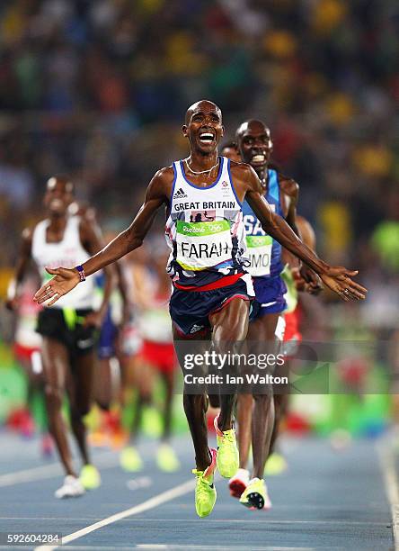 Mohamed Farah of Great Britain reacts after winning gold in front of Paul Kipkemoi Chelimo of the United States in the Men's 5000 meter on Day 15 of...