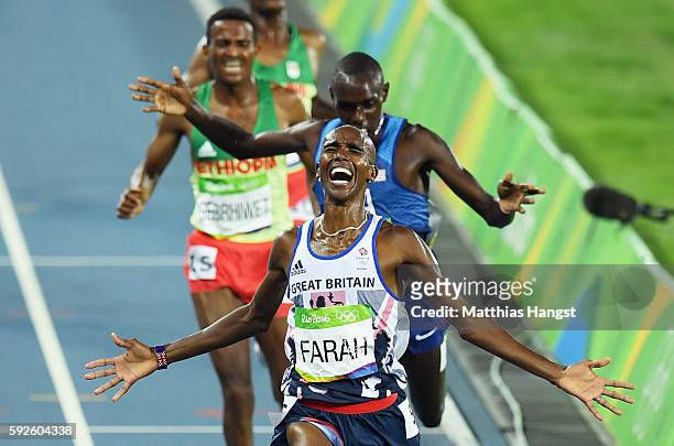 Mohamed Farah of Great Britain reacts after winning gold in front of Paul Kipkemoi Chelimo of the United States in the Men's 5000 meter on Day 15 of...