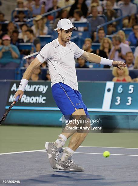 Andy Murray of Great Britain kicks a tennis ball in the semifinal match against Milos Raonic during day 8 of the Western & Southern Open at the...