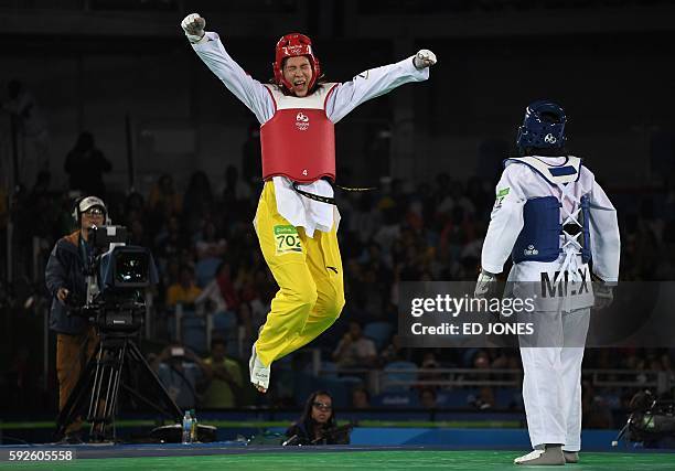 China's Zheng Shuyin celebrates after winning against Mexico's Maria del Rosario Espinoza Espinoza in the womens taekwondo gold medal bout in the...