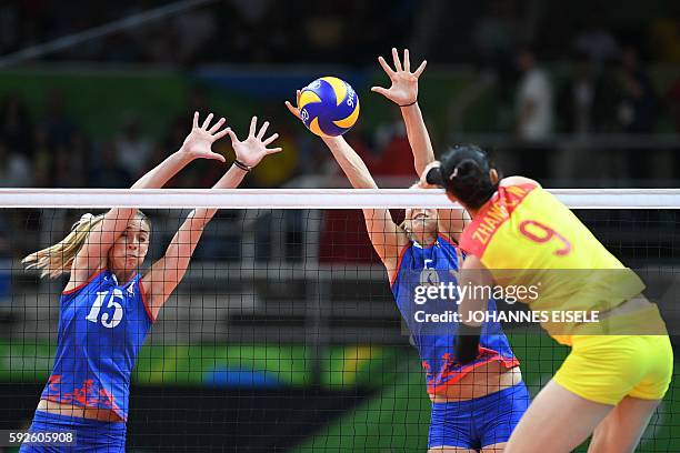 Serbia's Jovana Stevanovic and Serbia's Tijana Malesevic jump up to block the ball during the women's Gold Medal volleyball match between China and...