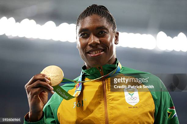 Gold medalist Caster Semenya of South Africa stands on the podium during the medal ceremony for the Women's 800 meter on Day 15 of the Rio 2016...