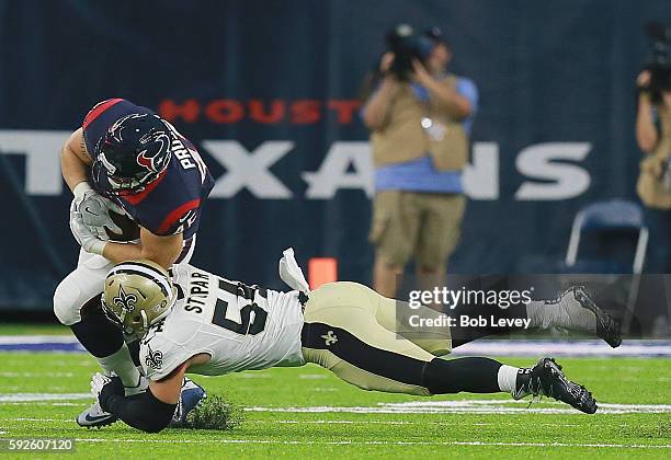 Jay Prosch of the Houston Texans is tackled by Nate Stupar of the New Orleans Saints during a preseason NFL game at NRG Stadium on August 20, 2016 in...