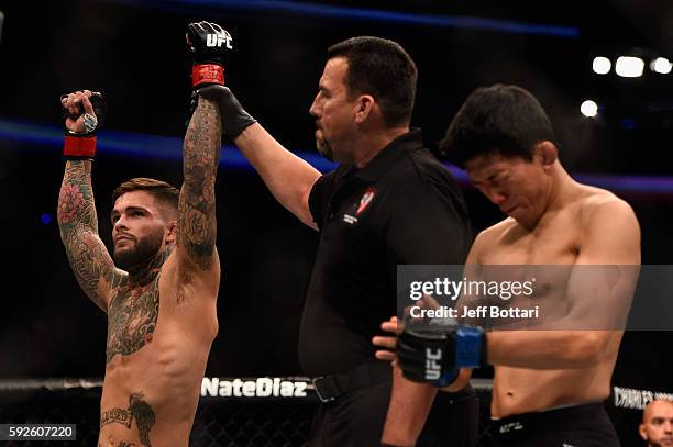 Cody Garbrandt celebrates after defeating Takeya Mizugaki of Japan in their bantamweight bout during the UFC 202 event at T-Mobile Arena on August...