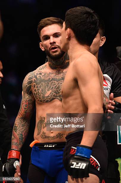 Cody Garbrandt talks to Takeya Mizugaki of Japan after defeating Mizugaki in their bantamweight bout during the UFC 202 event at T-Mobile Arena on...