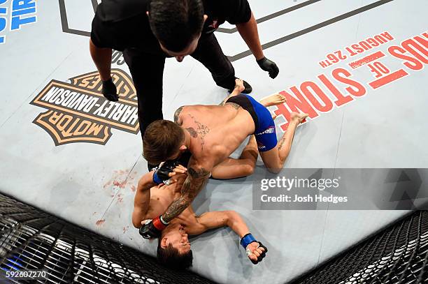 Cody Garbrandt punches Takeya Mizugaki of Japan in their bantamweight bout during the UFC 202 event at T-Mobile Arena on August 20, 2016 in Las...