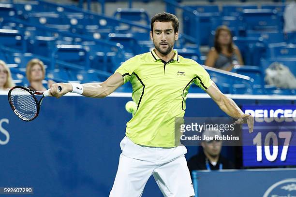 Marin Cilic of Croatia hits a return to Grigor Dimitrov of Bulgaria during a semifinal match on Day 8 of the Western & Southern Open at the Lindner...